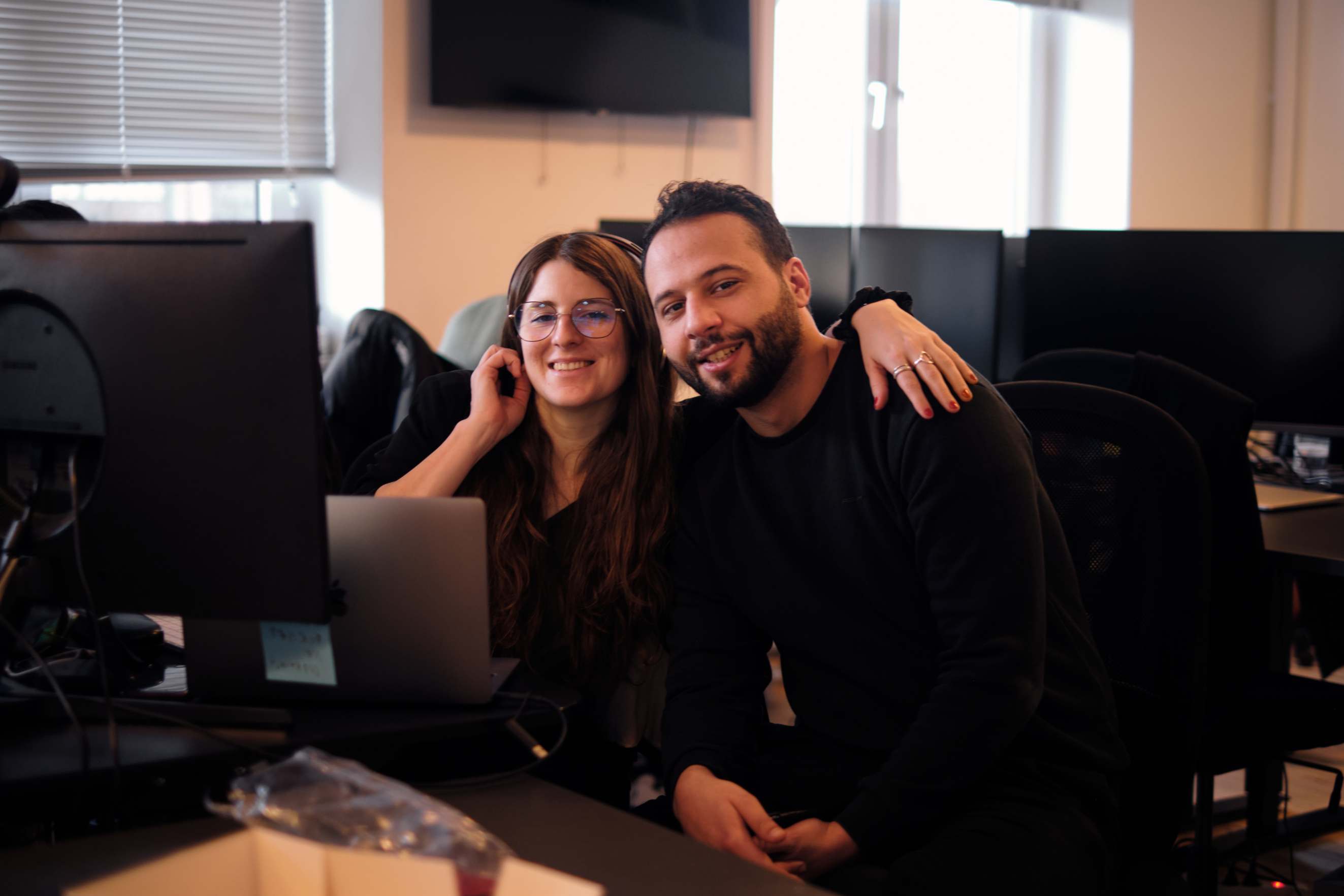 Photo of Clerk.io employees at the office smiling at the camera.