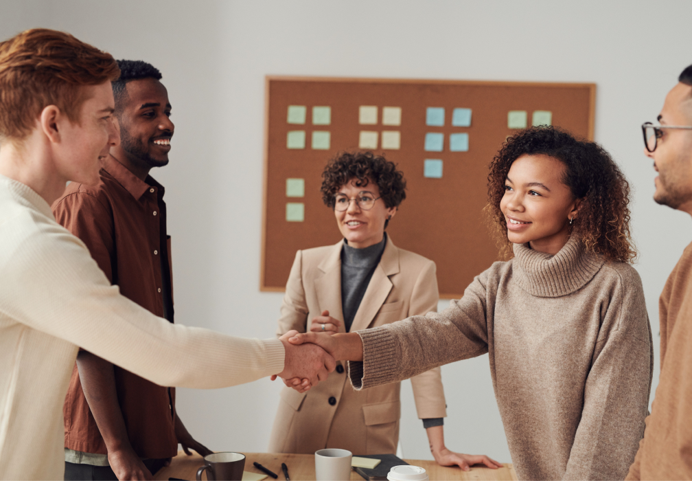 Image of people shaking hands in a work setting