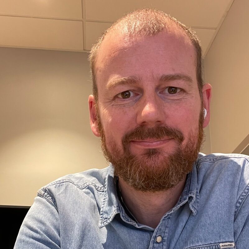Photo of a man smiling at the camera