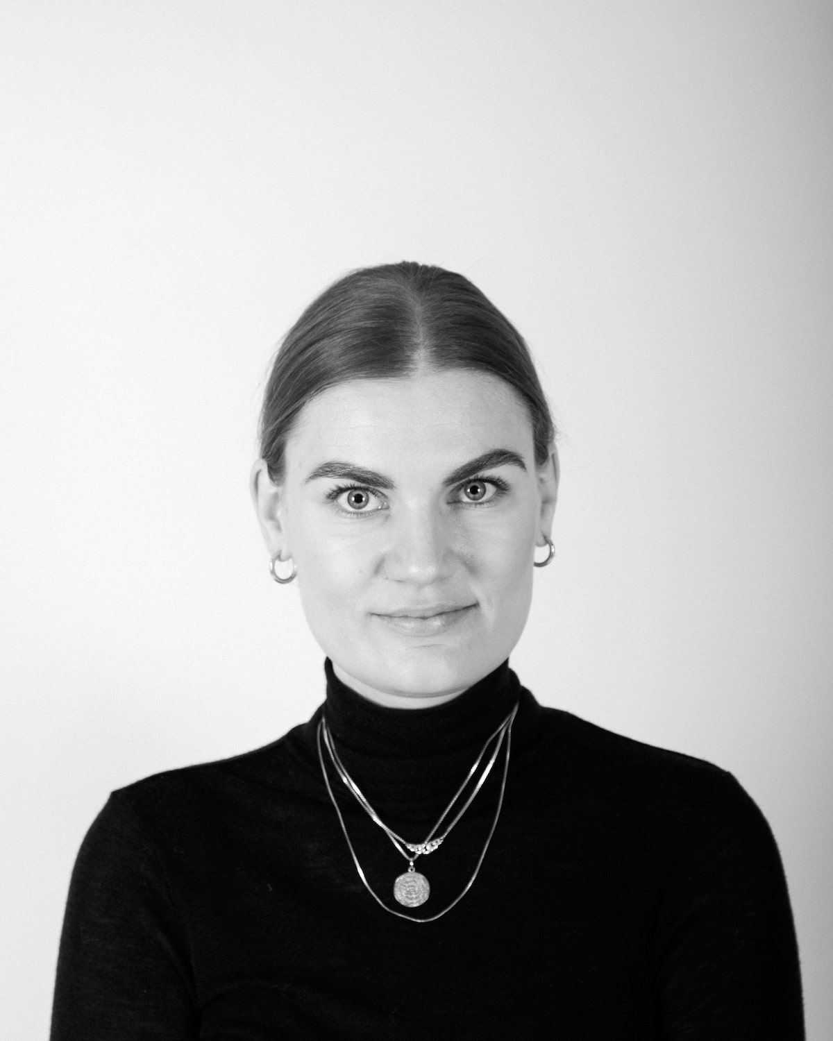 Black and white photo of a woman looking at the camera.